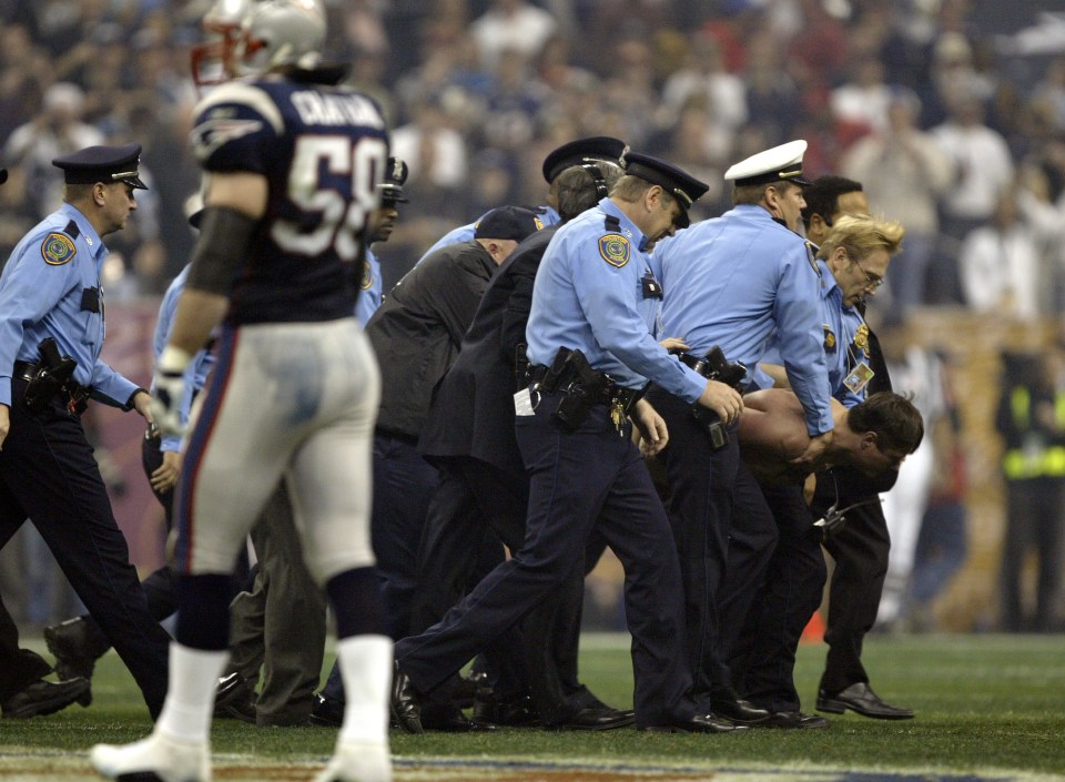 Roberts was escorted off the field after his bold stunt at Super Bowl XXXVIII