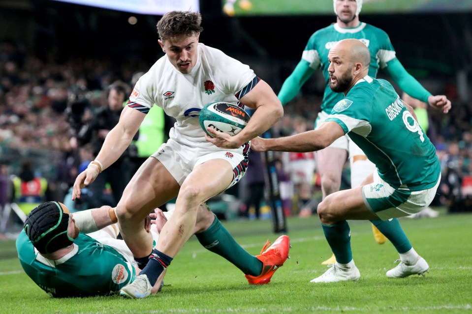 England rugby player running with the ball during a Six Nations match.