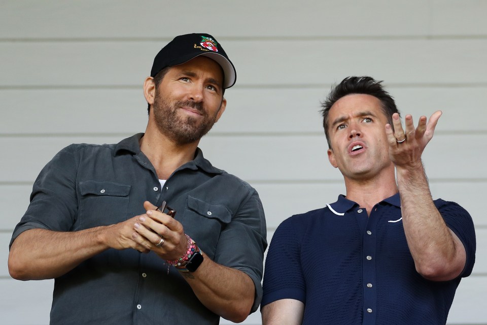 Ryan Reynolds and Rob McElhenney, co-owners of Wrexham AFC, react before a soccer match.