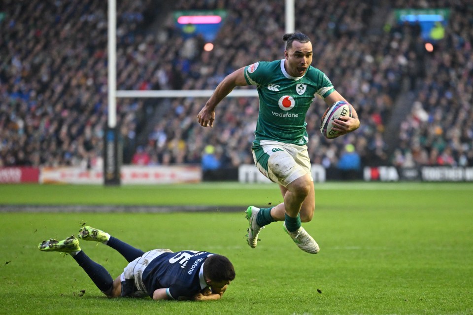 Ireland's James Lowe scores a try over Scotland's Blair Kinghorn during a Six Nations rugby match.