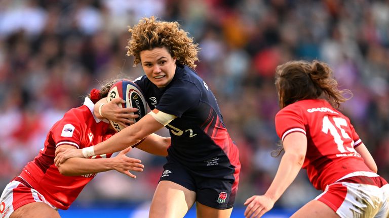 Ellie Kildunne of England is tackled by Hannah Jones and Jenny Hesketh of Wales during the Women's Six Nations