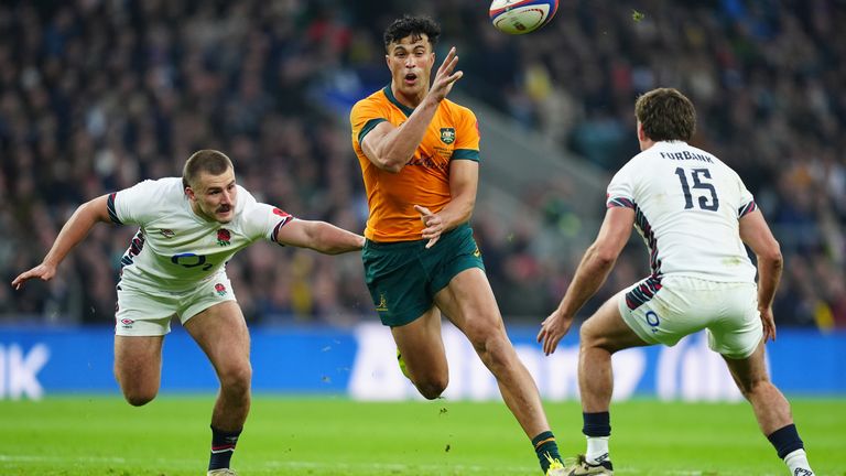 Australia's Joseph Suaalii (right) gets away from England's Ollie Sleightholme