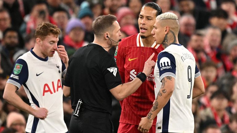 Referee Craig Pawson (C) talks to Tottenham Hotspur's Brazilian striker #09 Richarlison (R) and Liverpool's Dutch defender #04 Virgil van Dijk (2R) during the English League Cup semi-final second leg football match between Liverpool and Tottenham Hotspur at Anfield in Liverpool, north west England on February 6, 2025. (Photo by Oli SCARFF / AFP) / RESTRICTED TO EDITORIAL USE. No use with unauthorized audio, video, data, fixture lists, club/league logos or 'live' services. Online in-match use limited to 120 images. An additional 40 images may be used in extra time. No video emulation. Social media in-match use limited to 120 images. An additional 40 images may be used in extra time. No use in betting publications, games or single club/league/player publications. / 