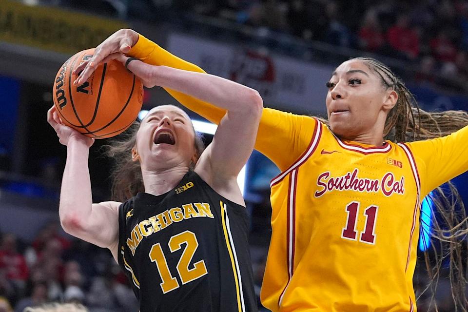 USC guard Kennedy Smith, right, fouls Michigan guard Syla Swords while trying to block a shot.