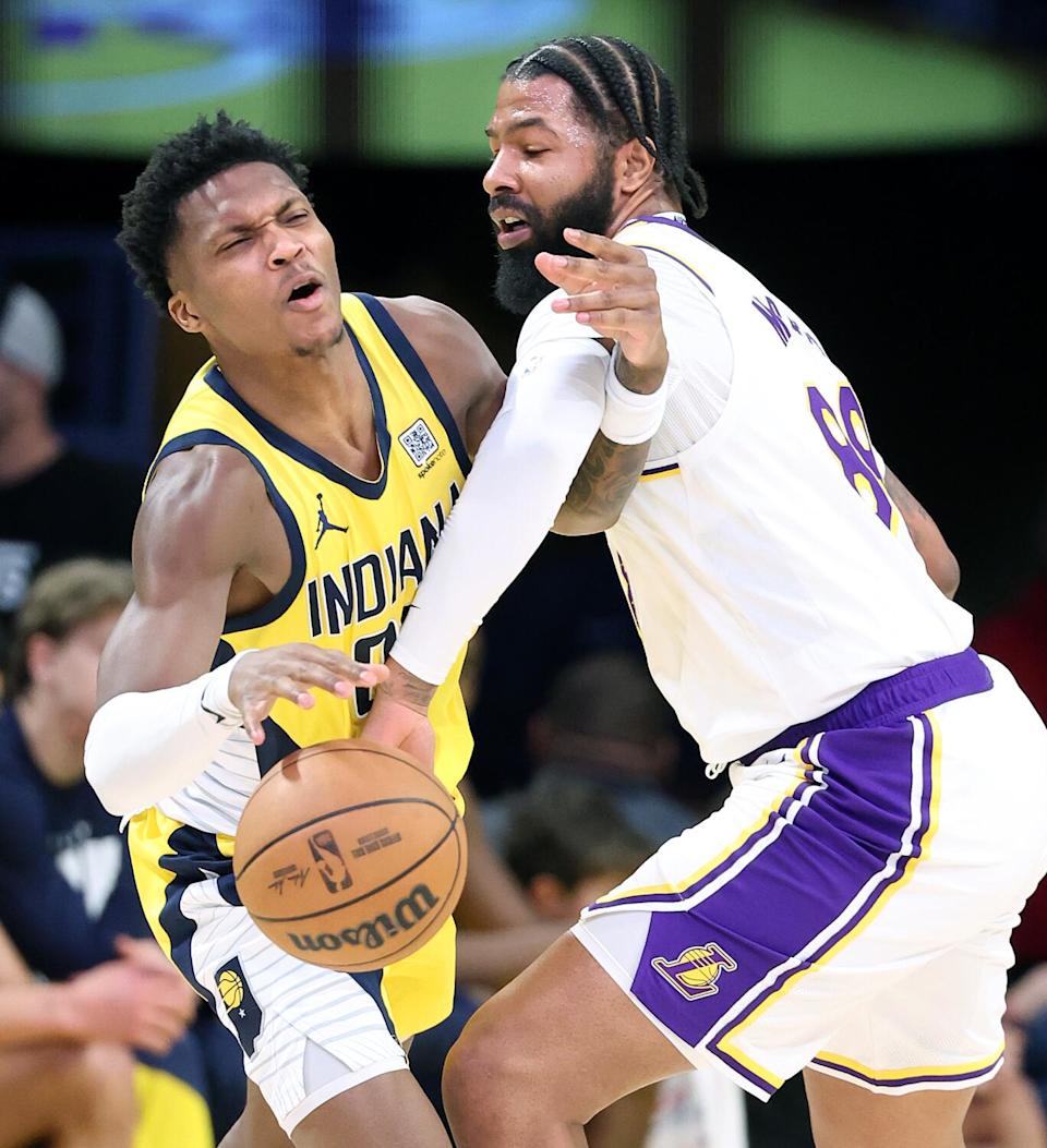 Lakers forward Markieff Morris knocks the ball away from Pacers forward Bennedict Mathurin.