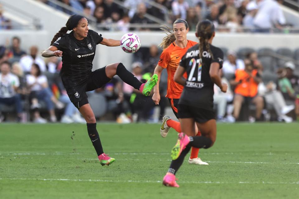 Angel City's Sydney Leroux controls the ball in front of Houston's Katie Lind near Leroux's teammate Alyssa Thompson