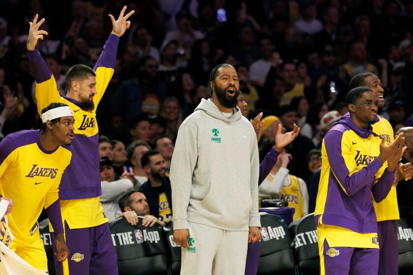 LOS ANGELES, CA - MARCH 6, 2025: Lakers Markieff Morris, center, cheers on his team during the overtime win over the New York Knicks at Crypto.com Arena on March 6, 2025 in Los Angeles, California. (Gina Ferazzi / Los Angeles Times)