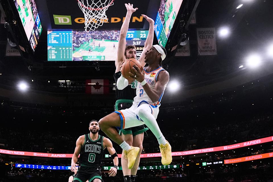 Oklahoma City Thunder guard Shai Gilgeous-Alexander (2) drive to the basket against Boston Celtics Middle Luke Kornet, rear right, and forward Jayson Tatum (0) during the Primary half of an NBA basketball game, Wednesday, March 12, 2025, in Boston. (AP Photo/Charles Krupa)