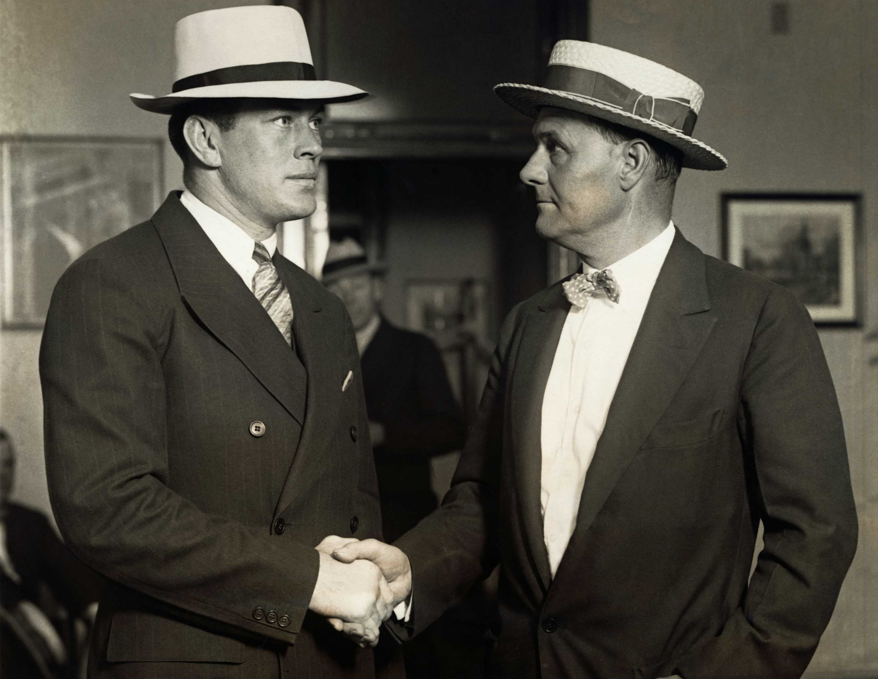 (Original Caption) Gene Tunney shaking hands with Tex Rickard in the fight promoter's office after discussing with him plans for the battle in which Tunney will defend his title against Jack Dempsey. (Photo by George Rinhart/Corbis via Getty Images)