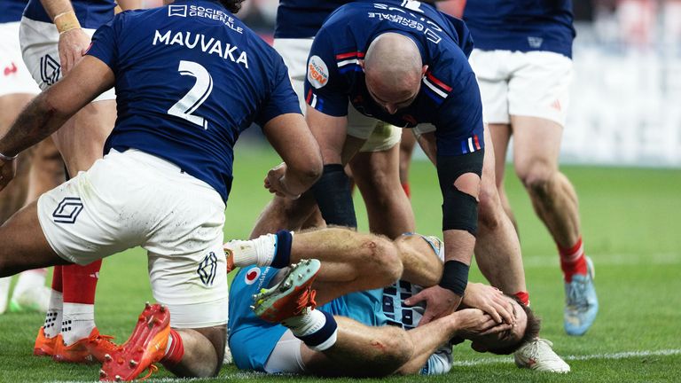 Scotland's Ben White clutches his face after appearing to be headbutted by France's Peato Mauvaka